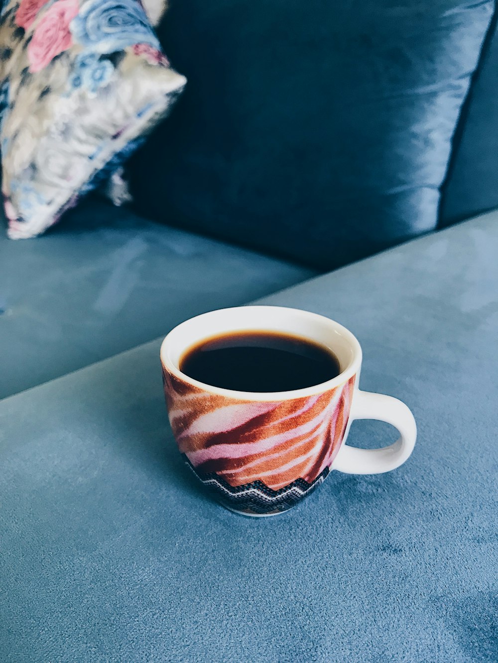 white and brown cup on gray surface