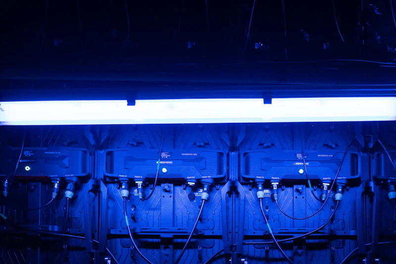 Rack hardware and cables lit in deep blue light