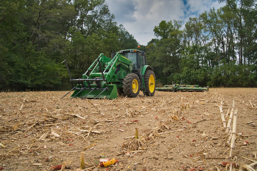 green harvester on brown soil