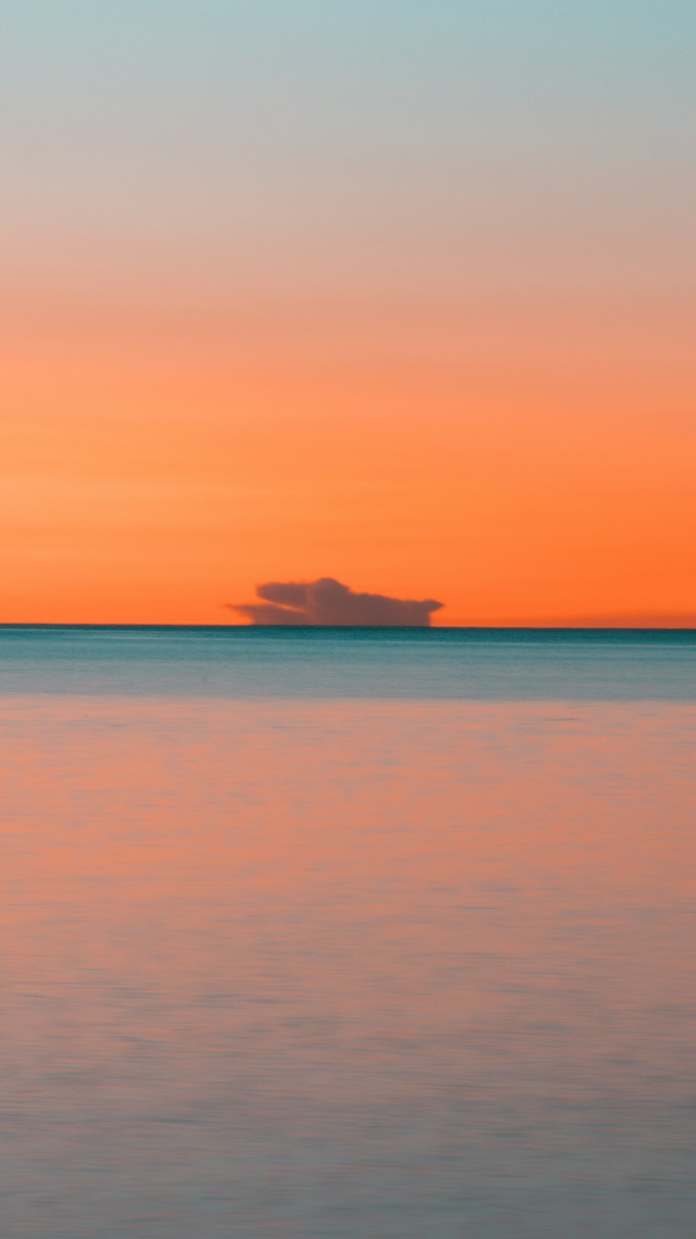 body of water across horizon during sunset