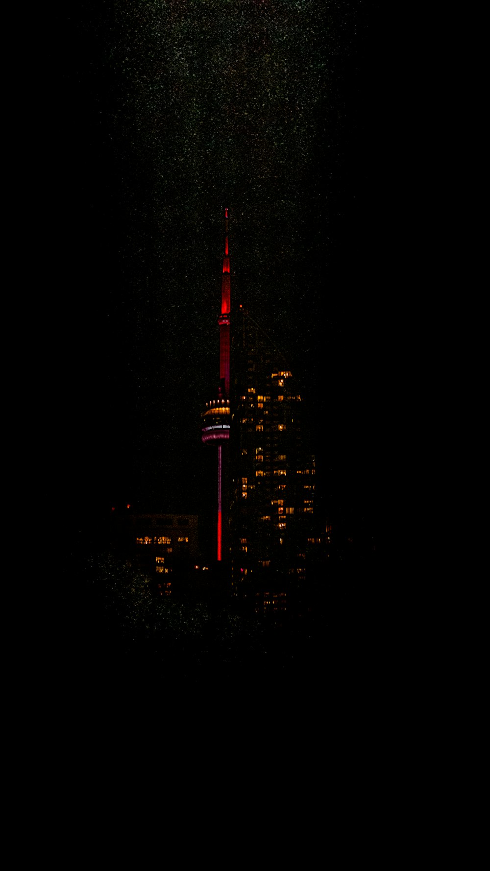 a very tall building with a red light on it's side