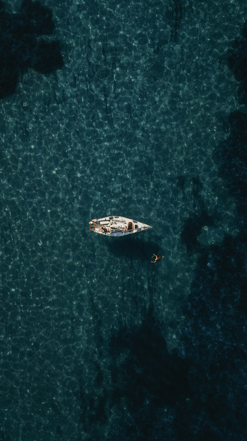 Vista a volo d'uccello della barca bianca sullo specchio d'acqua