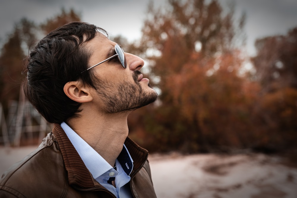 man wearing brown leather jacket