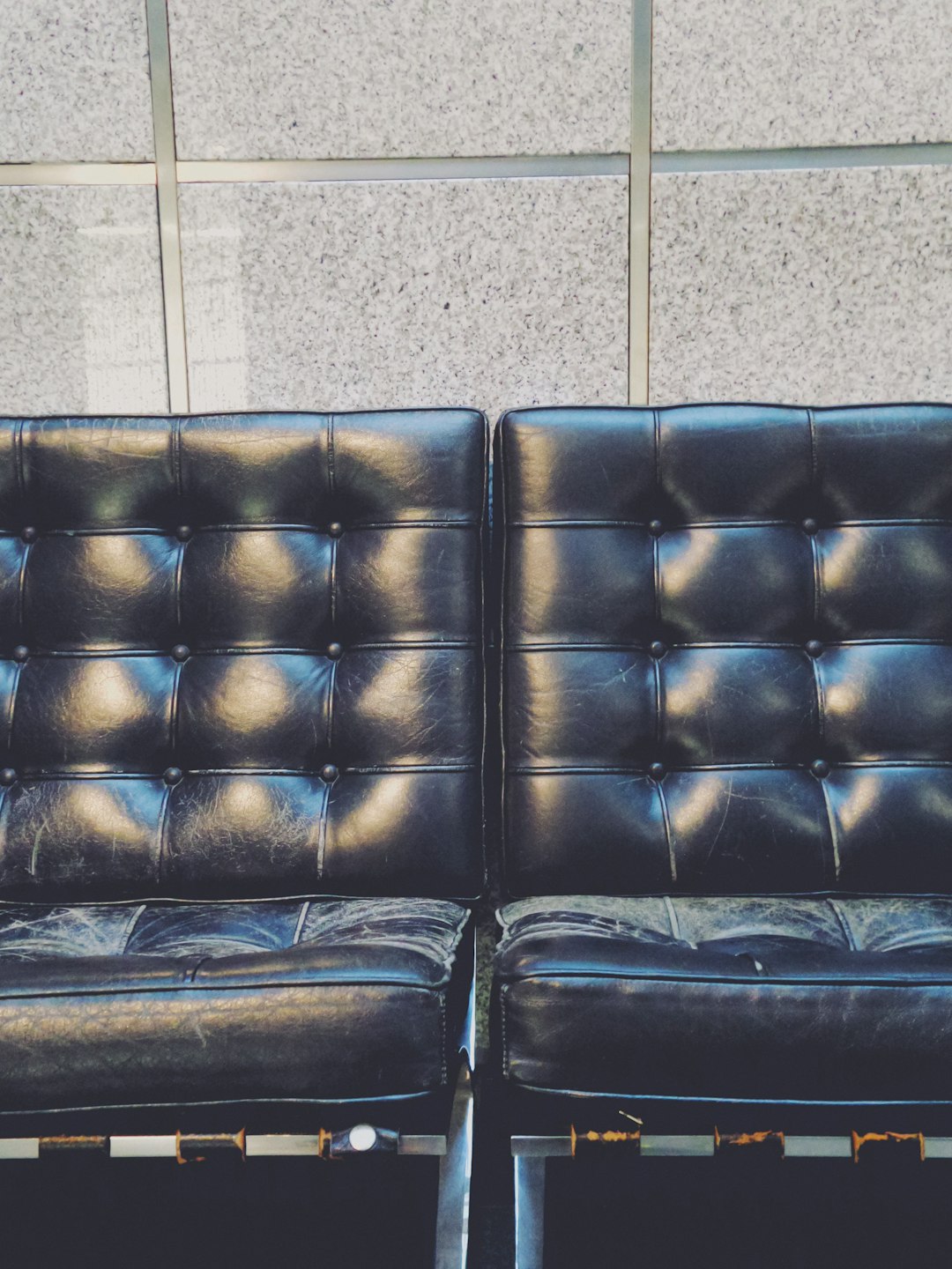 tufted black leather sofa