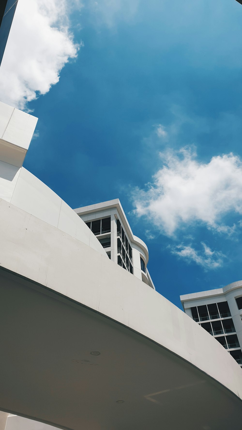 white painted building under white clouds