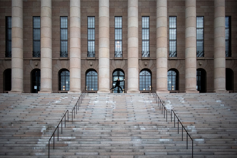 beige and brown staircase near pillars