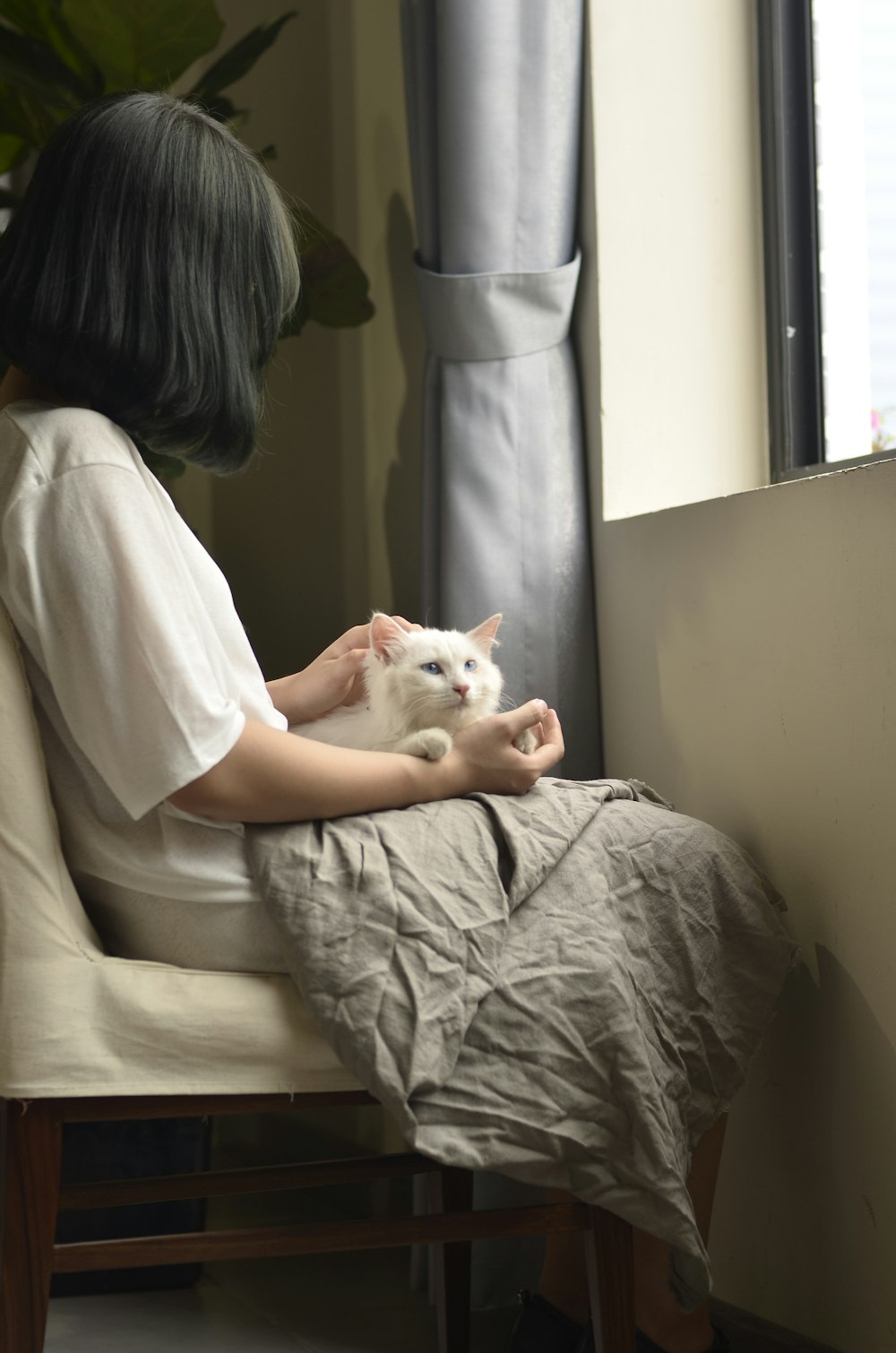 woman sitting with cat on lap