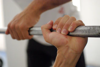 person holding barbell bar