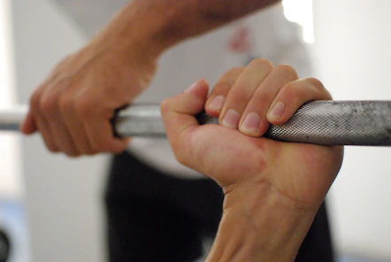 person holding barbell bar