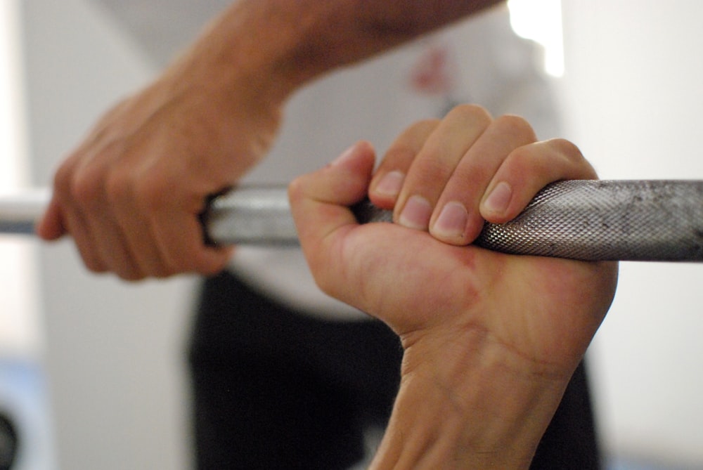 person holding barbell bar
