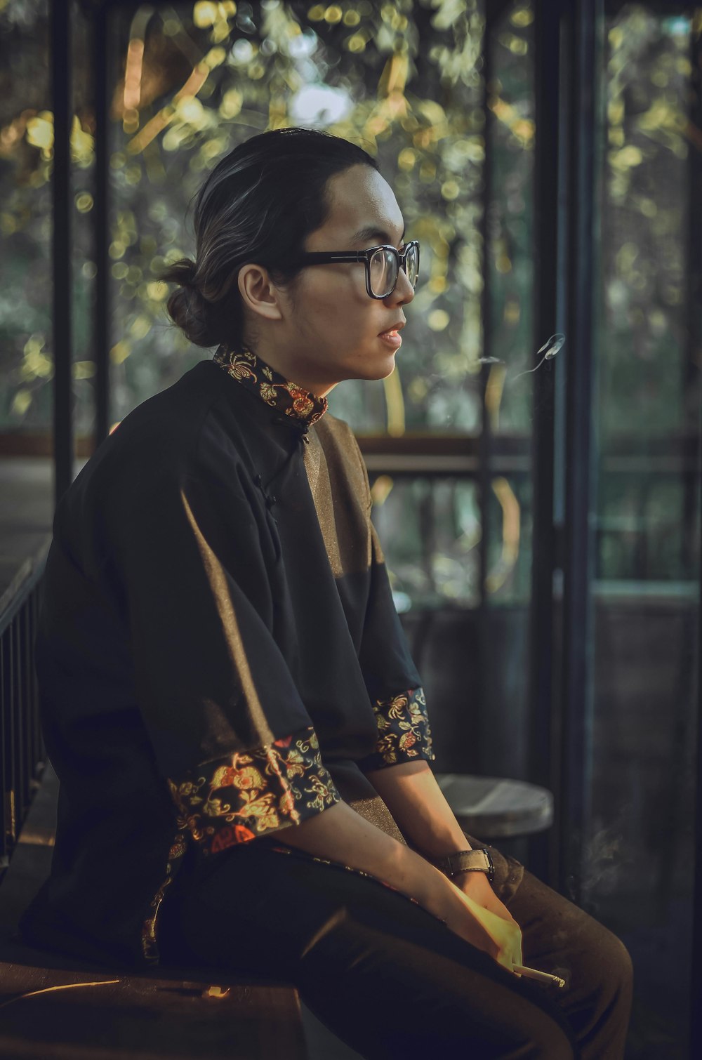 shallow focus photo of man wearing eyeglasses with black frames