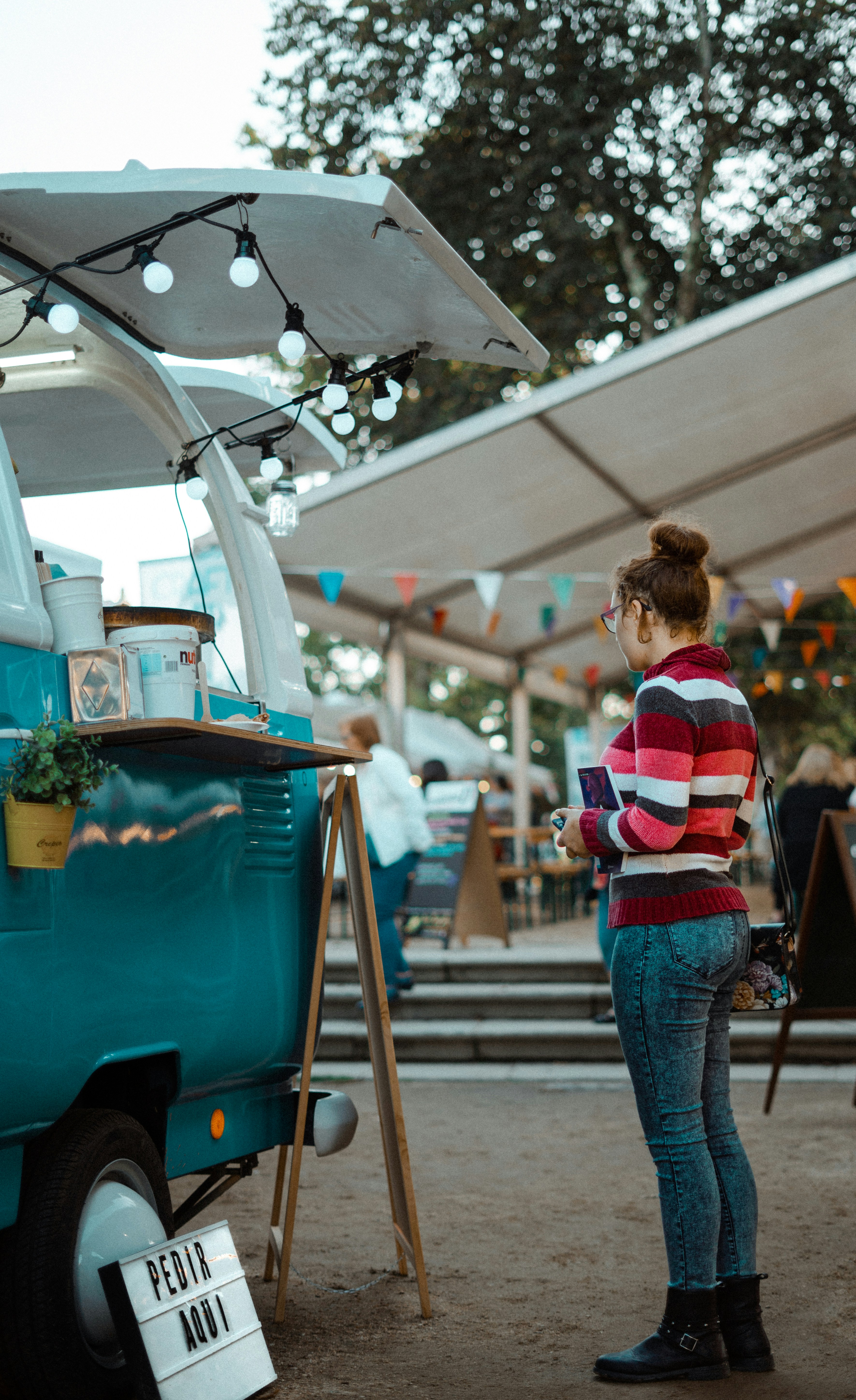 woman standing in front of bus at daytime