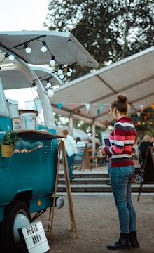 woman standing in front of bus at daytime