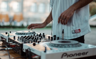 man playing Pioneer DJ controller