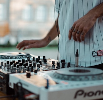man playing Pioneer DJ controller