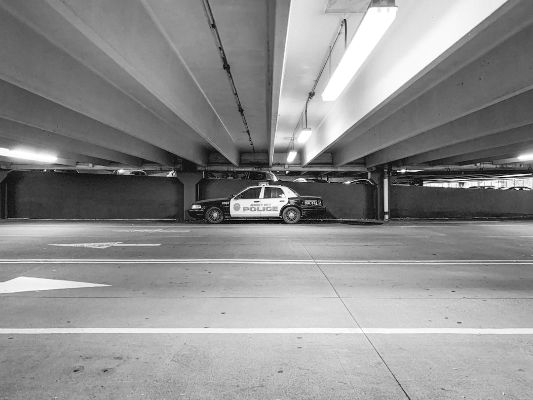 grayscale photography of police car on road