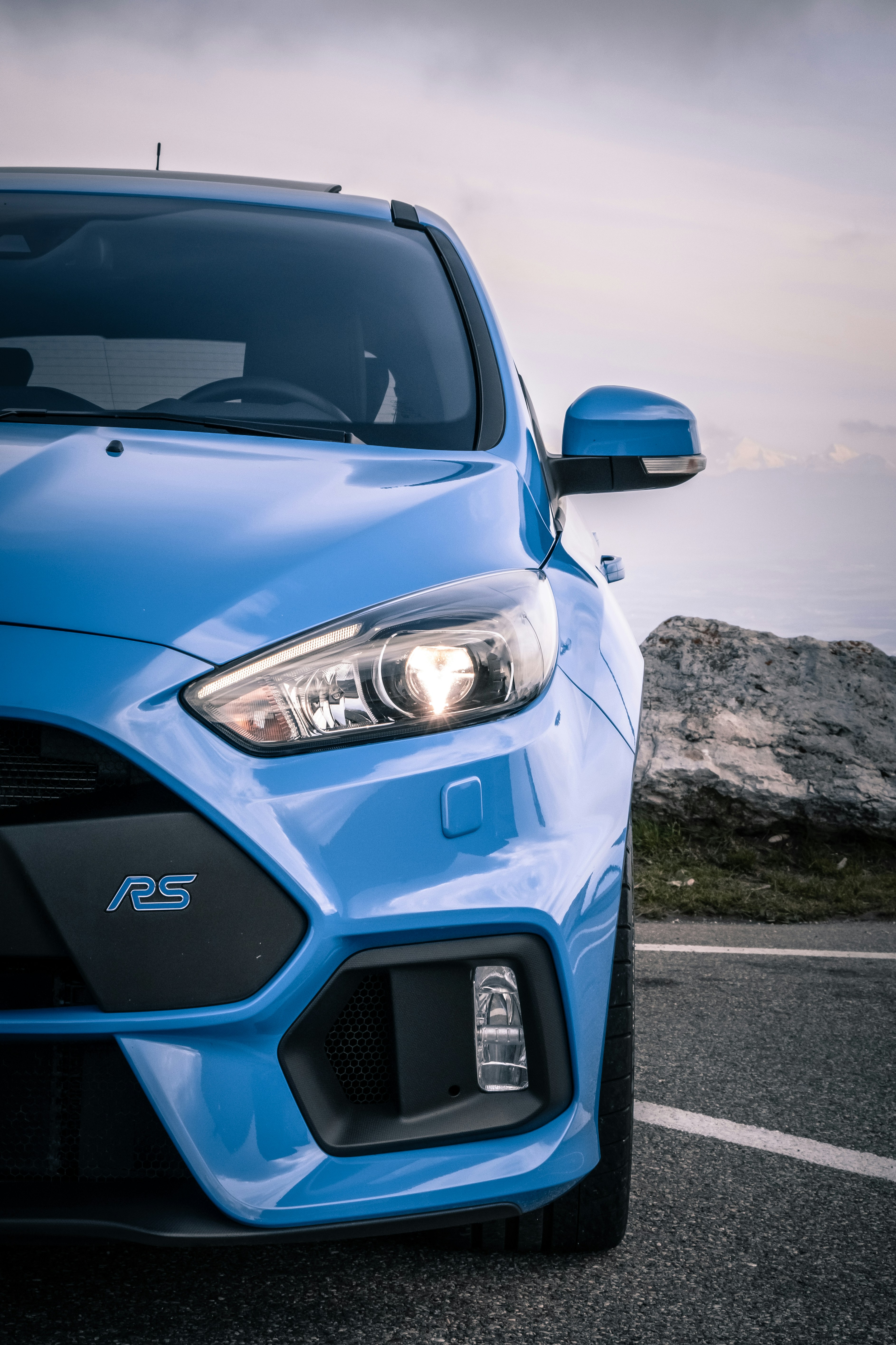 blue vehicle parked during daytime