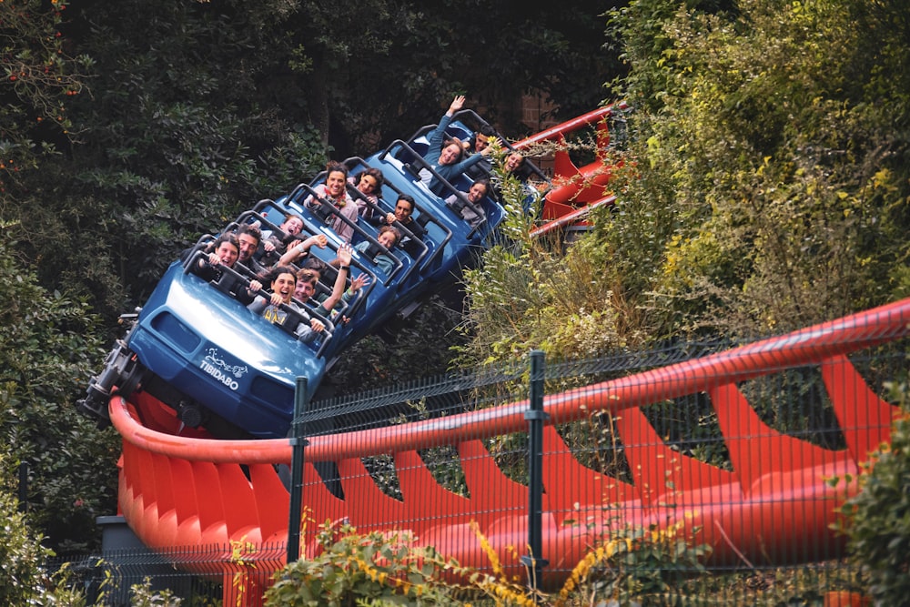 people riding on roller coaster