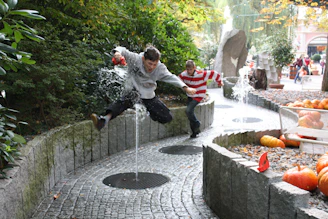 Children engaging with interactive educational exhibits in an outdoor park setting.