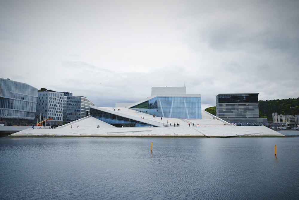 white concrete building beside calm water at daytime