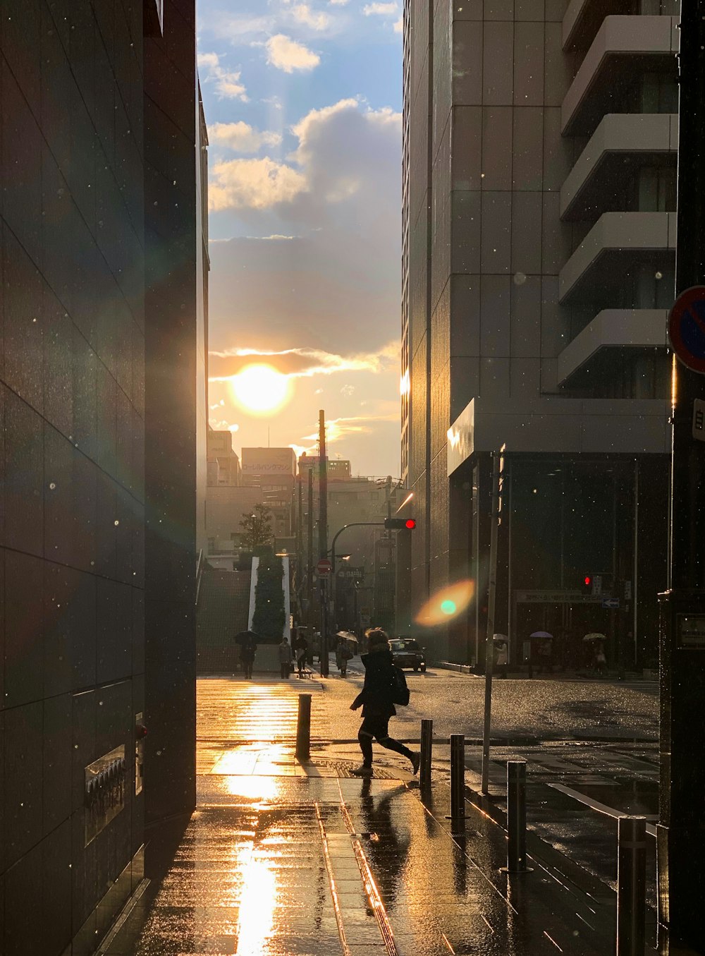 man walking near concrete buildings