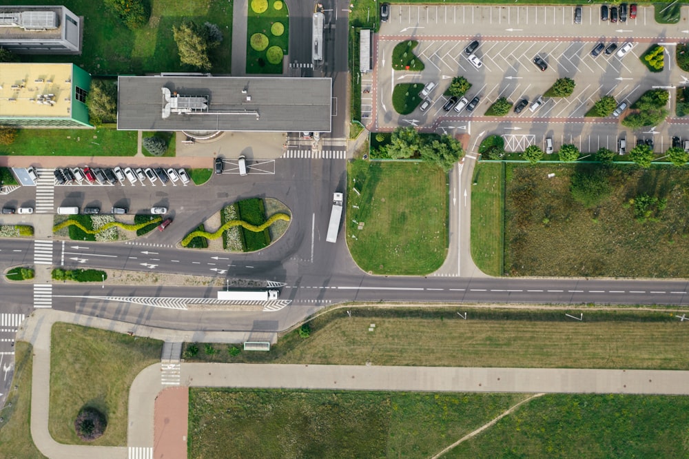 vehicles on road and parked on parking lot during day