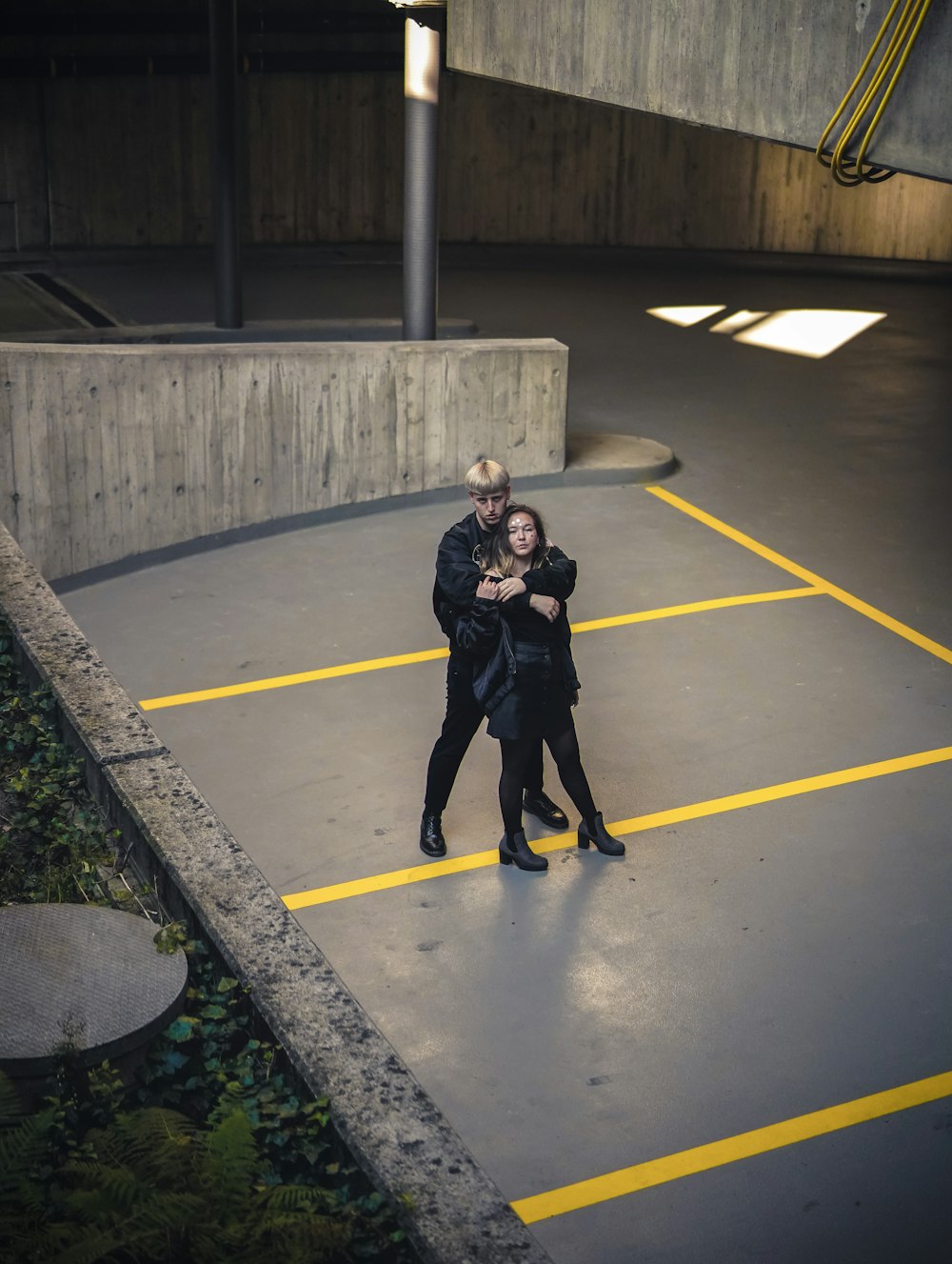 man and woman standing near concrete railings