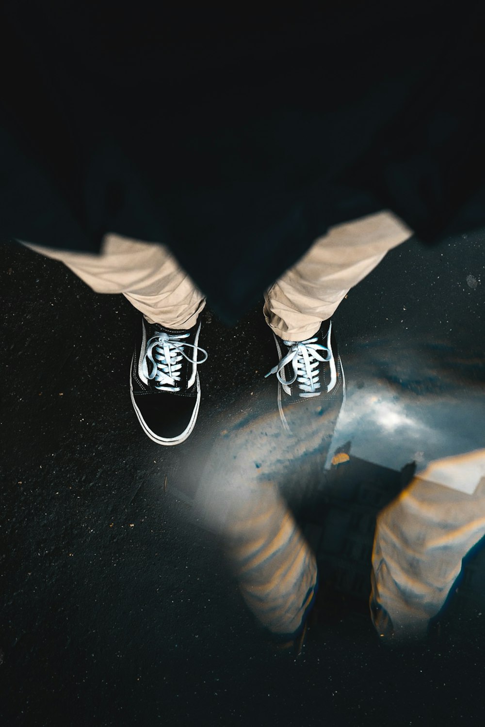 sitting person wearing black low-top sneakers