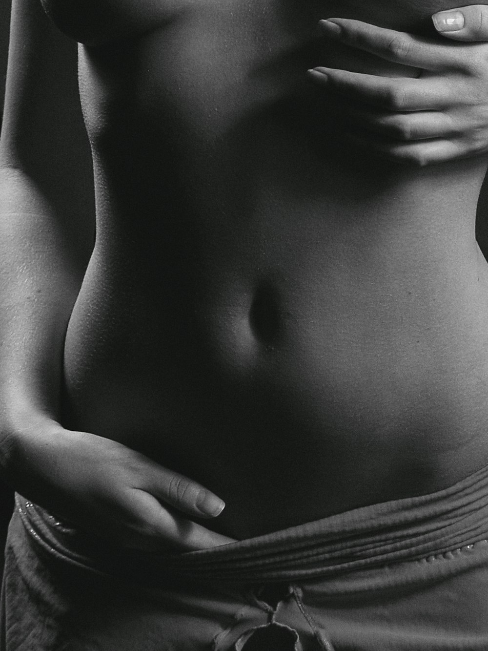 a black and white photo of a woman's stomach