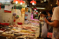 A vibrant seafood market bustling with fresh catches and lively traders.