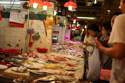 Fresh seafood being prepared by chefs in a modern kitchen with ocean view.