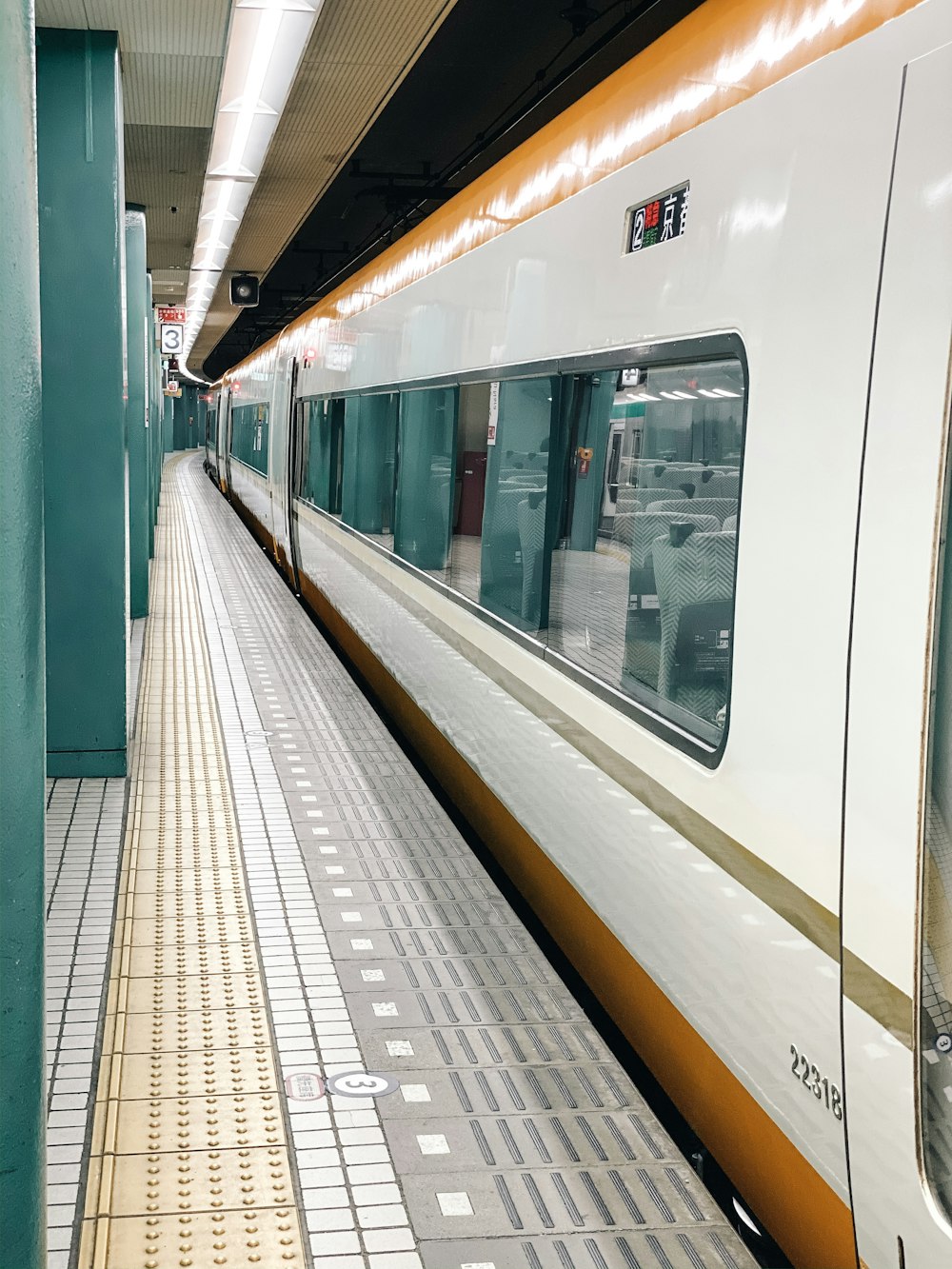 white and orange train on train station