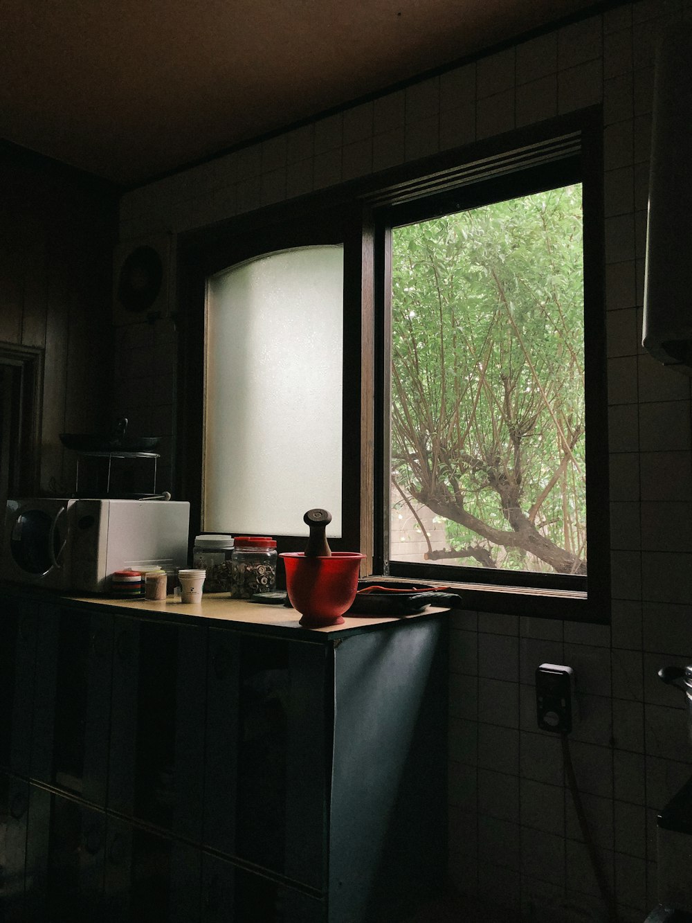 mortar and pestle beside full-pane slide windows