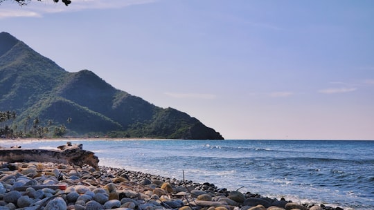 rocks on shore, mountains, and sea in Cuyagua Venezuela
