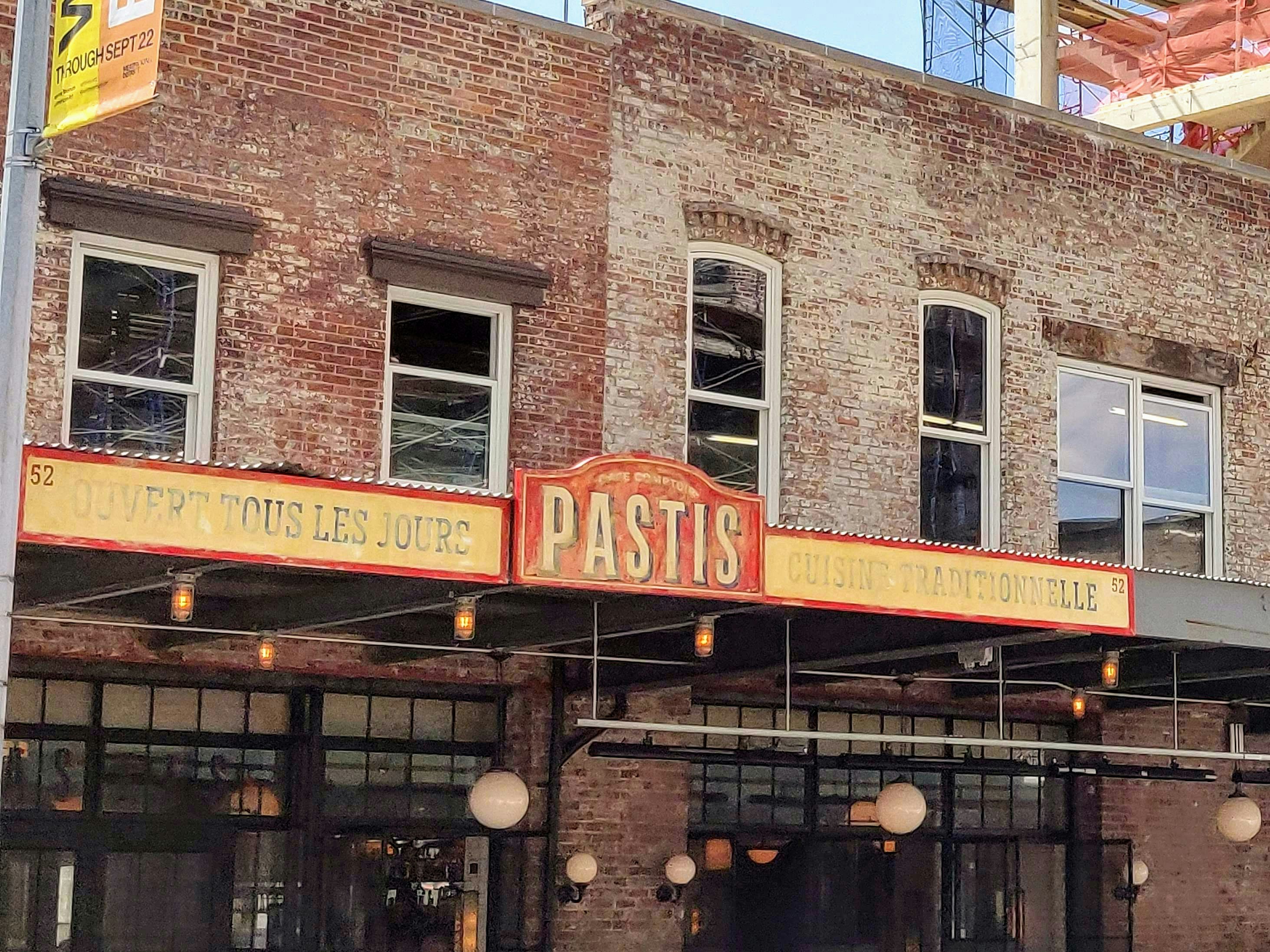 red and yellow Pastis store sign