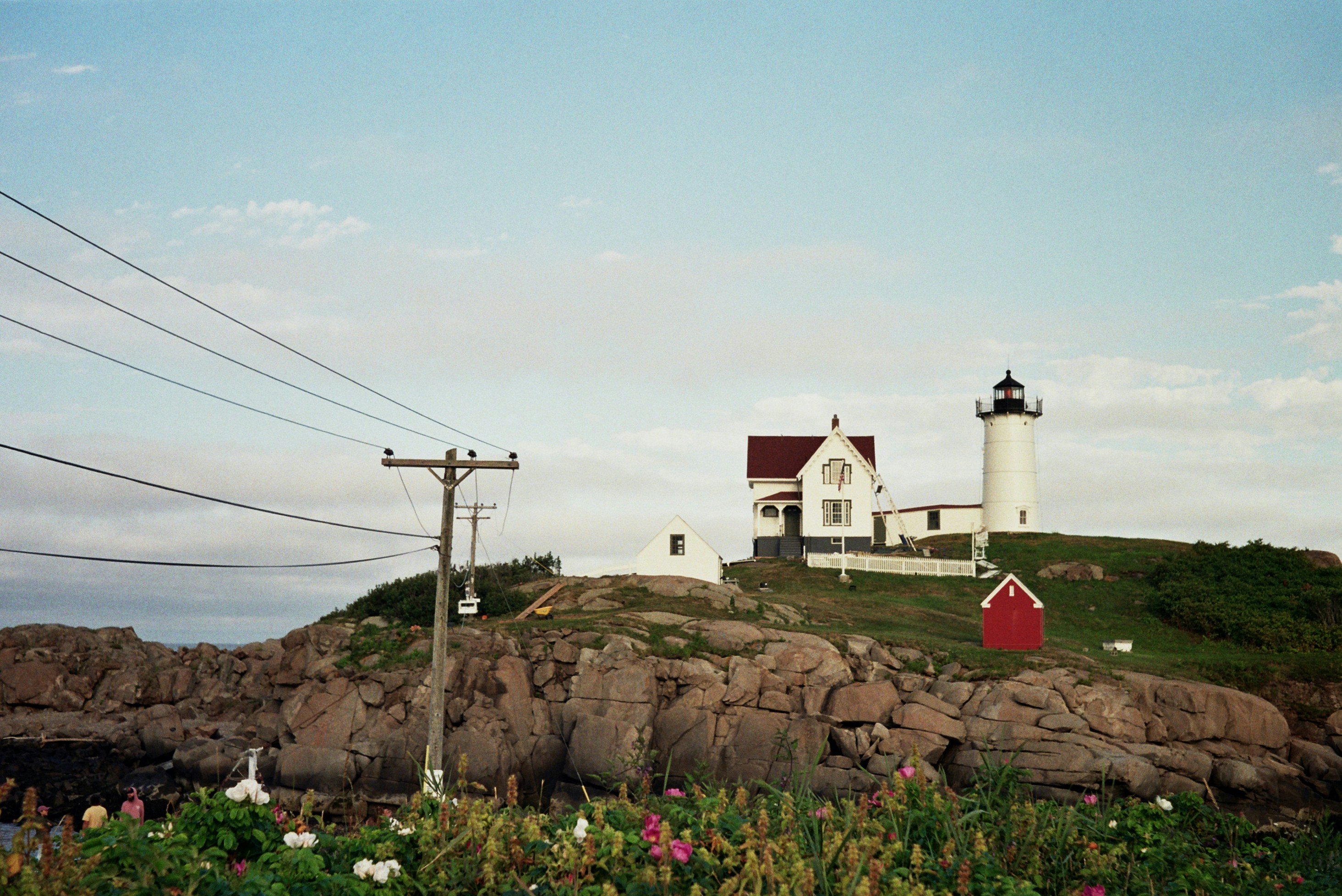 lighthouse on a hill under a calm blue sky