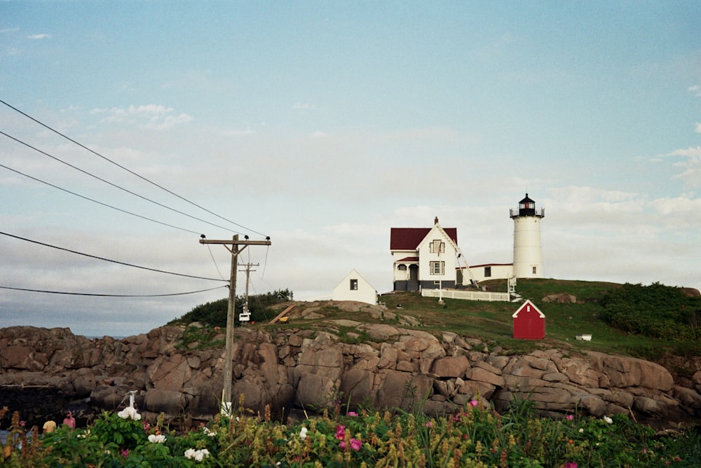 lighthouse on a hill under a calm blue sky