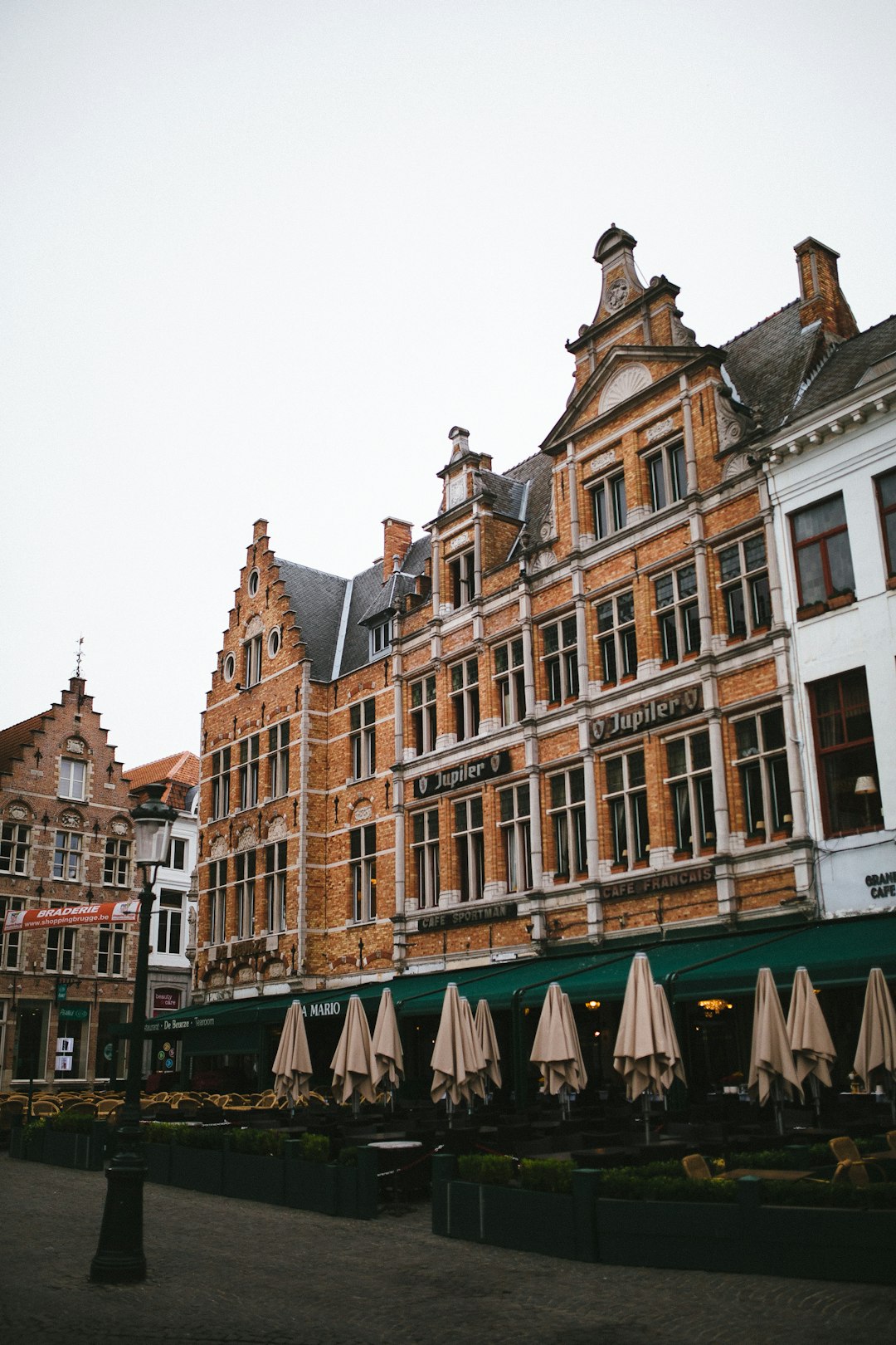 brown buildings under cloudy sky