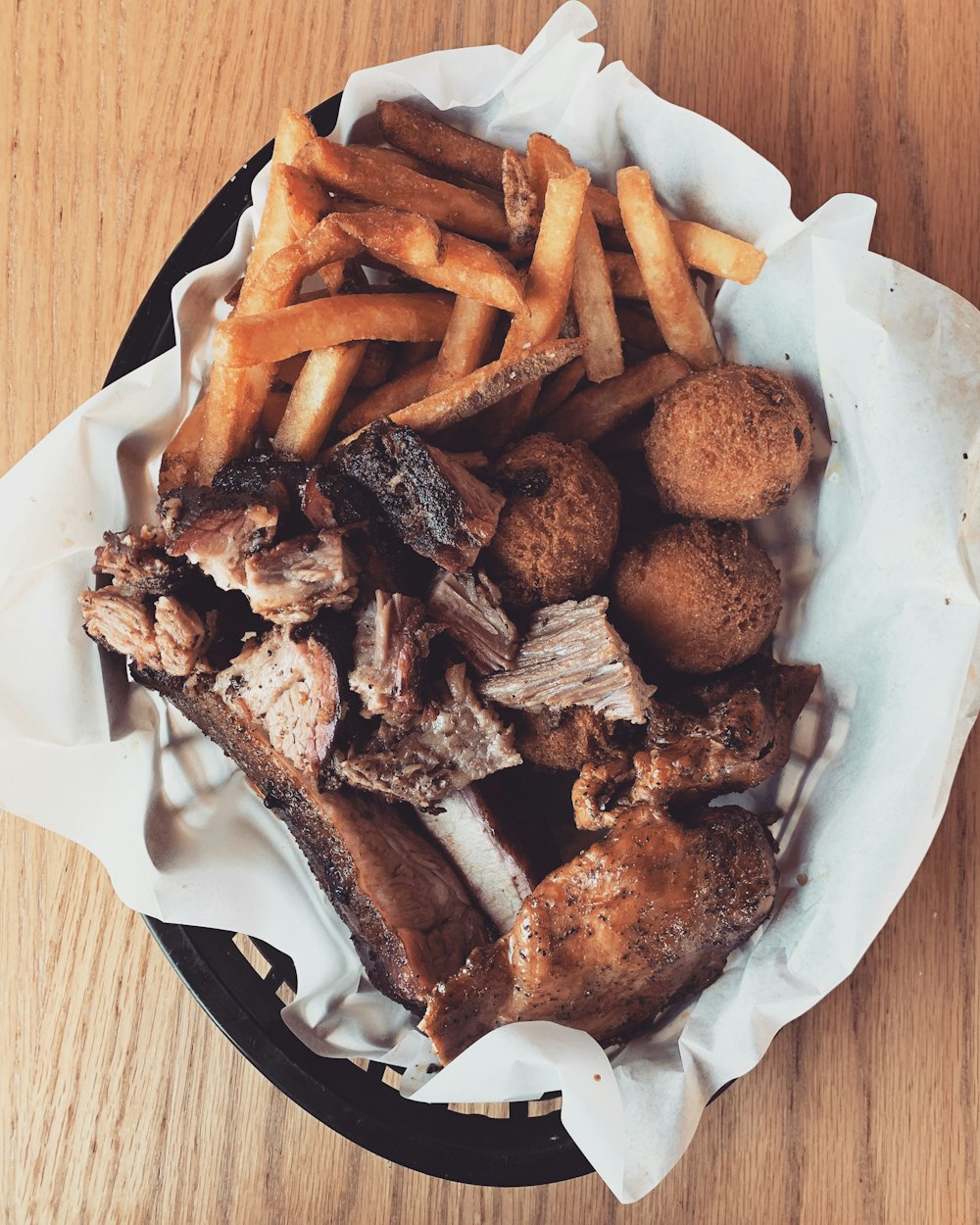 steak, meat balls, and fries in basket