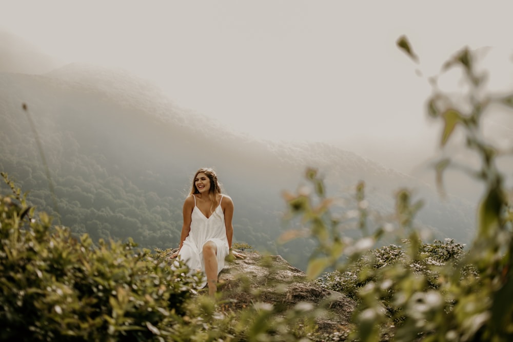 shallow focus photo of woman in white spaghetti strap dress