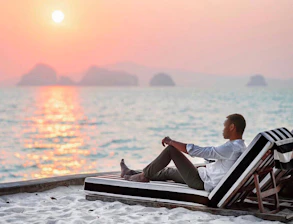 A confident retiree relaxing on a Thai beach, symbolizing retirement visa support.