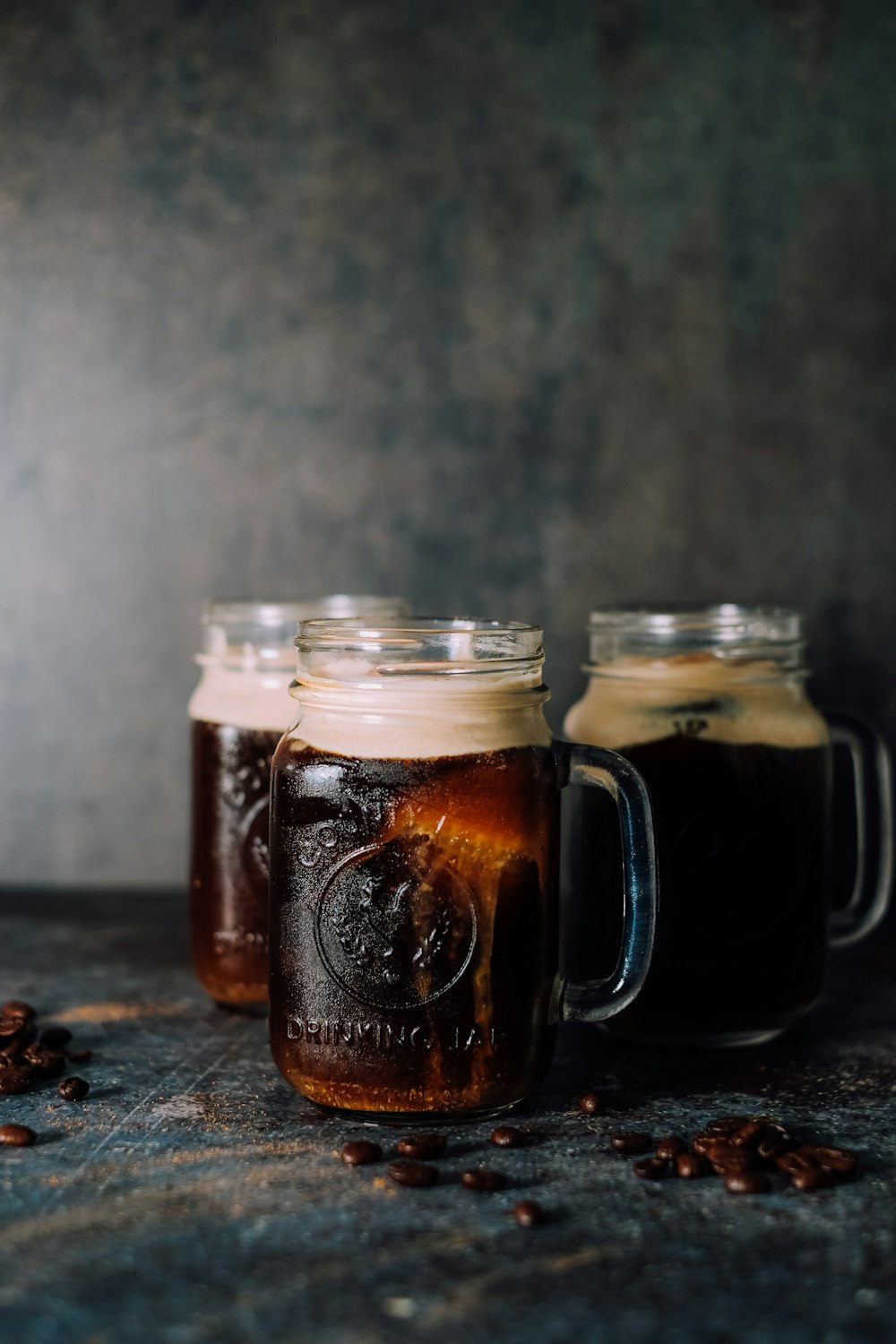 3 filled jar mugs by wall