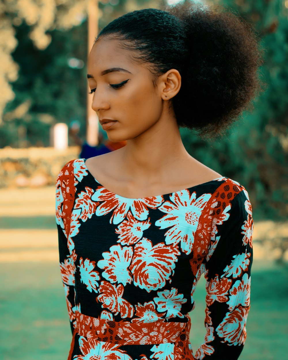 woman wearing black, white and orange floral dress