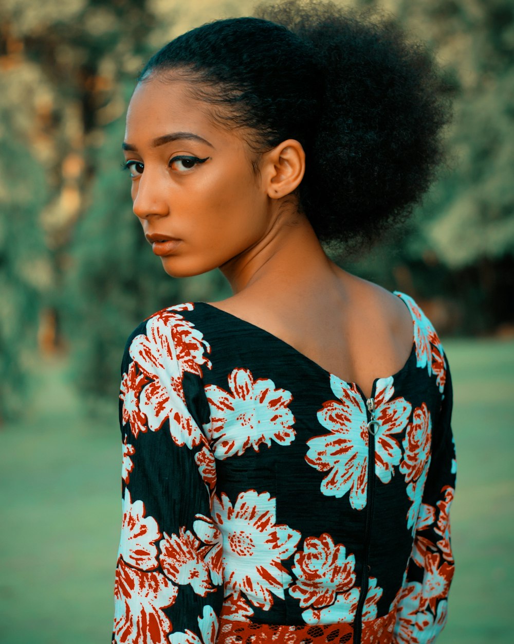 woman in black, red, and white floral long-sleeved shirt