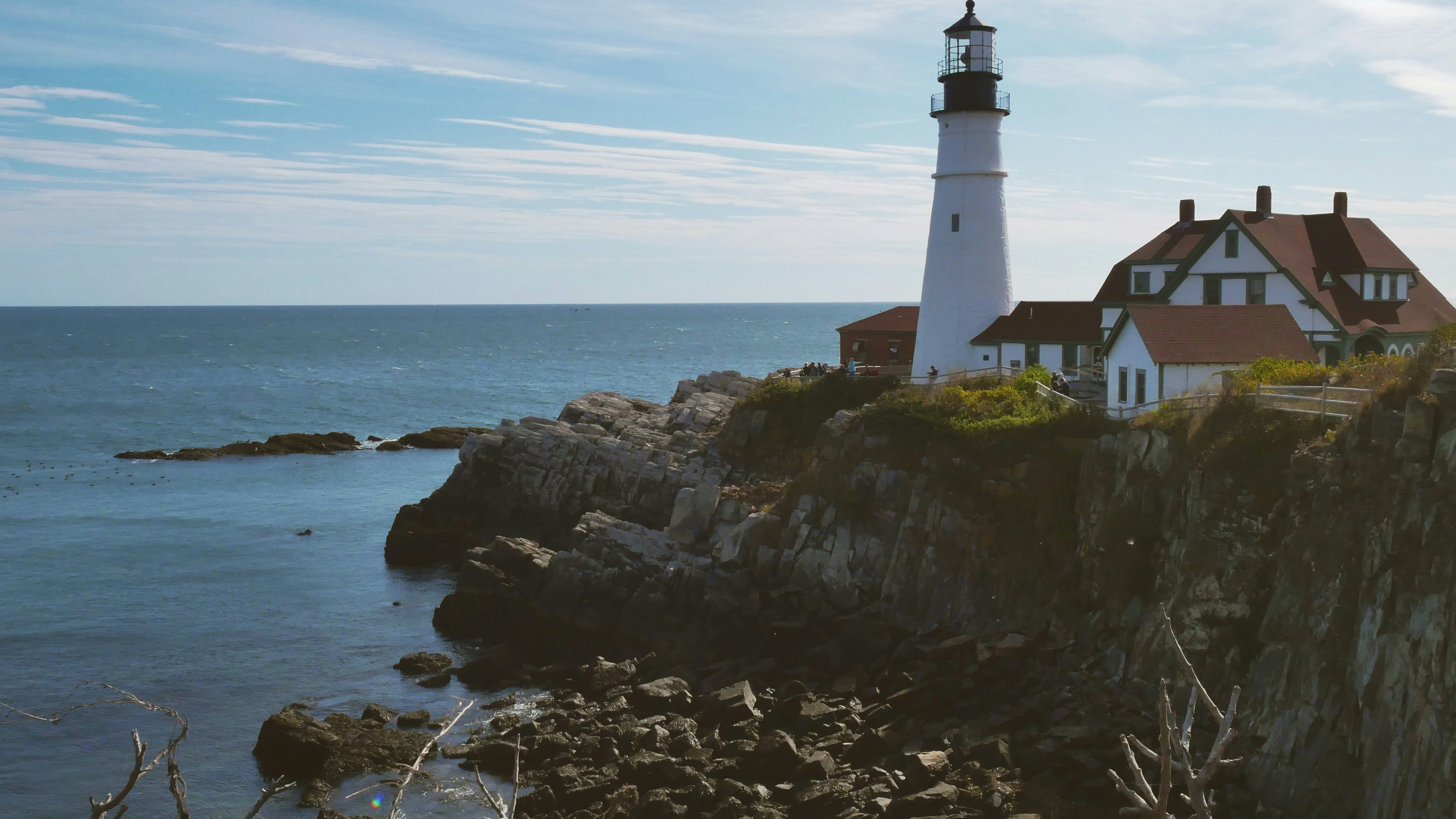 lighthouse on hill facing ocean