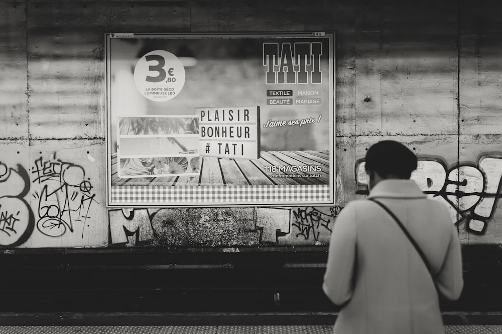 person facing wall with mural