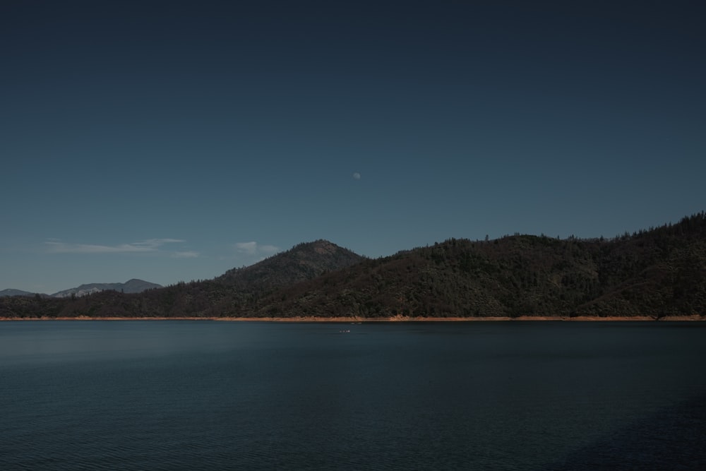 landscape photography of green mountains and blue sea during daytime