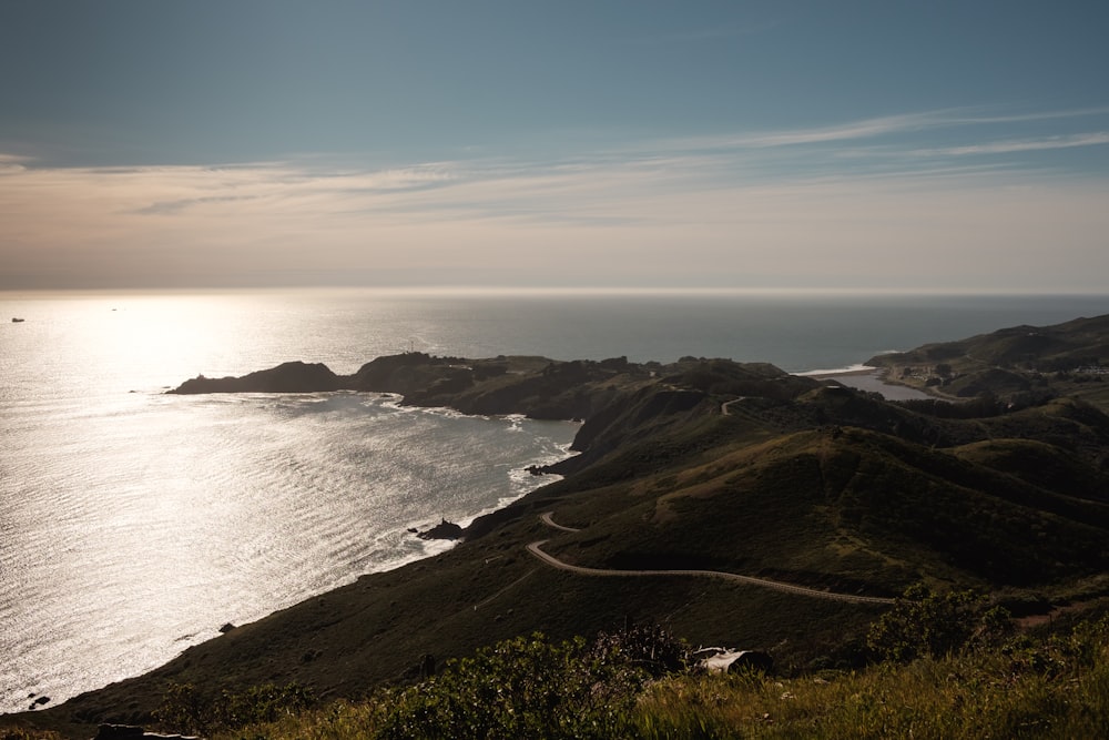 grass and road island during day