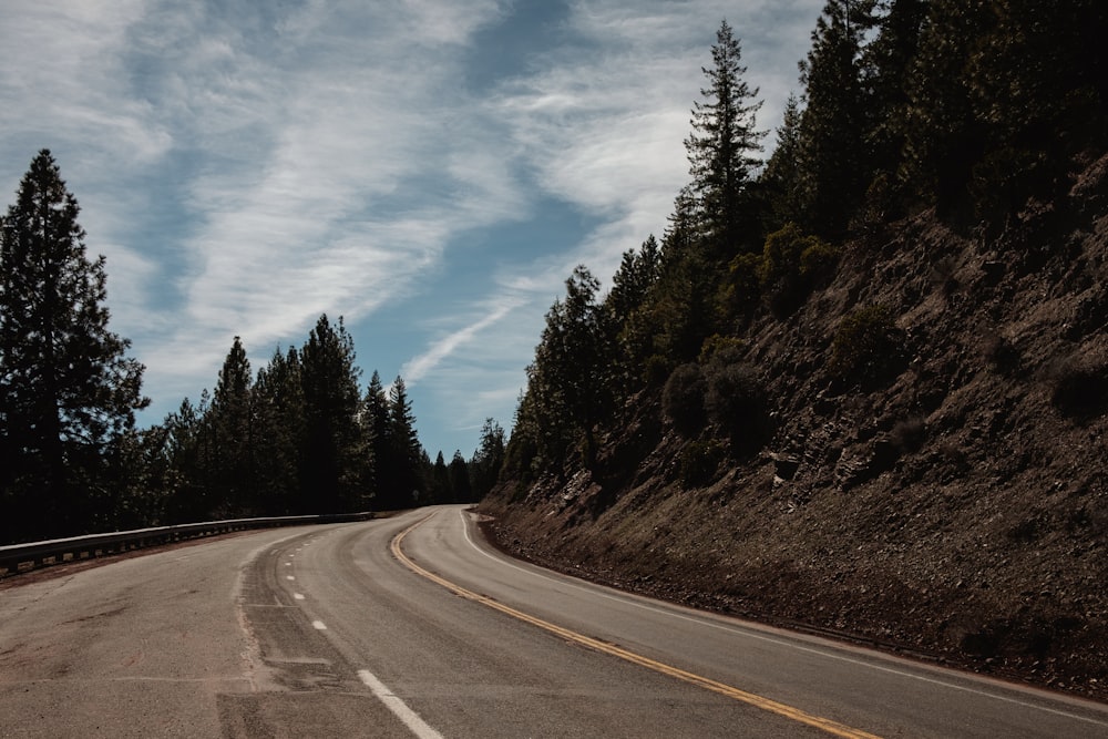 curved concrete road on the side of a mountain