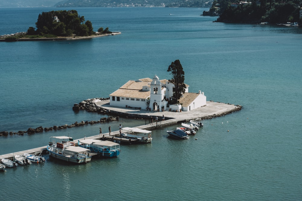 house on dock near docked boats during day